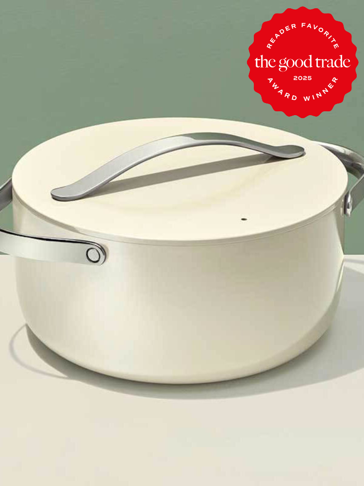 Cream-colored pot with a lid on a light surface. Features silver handles and a red "The Good Trade 2023 Reader Favorite Award Winner" badge in the upper right corner.