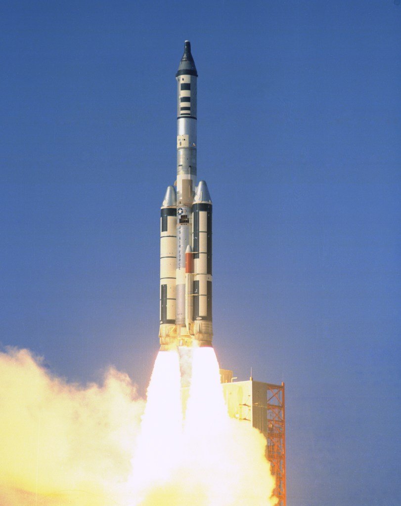 Image of a black capsule atop a rocket during liftoff.