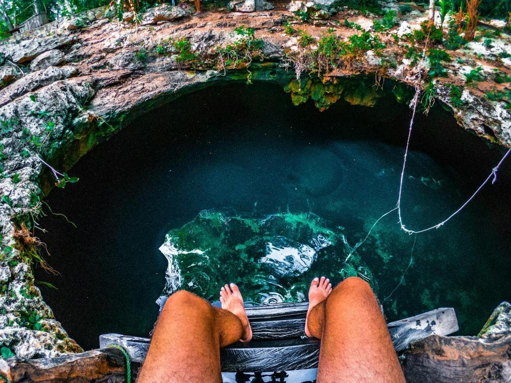 An exhilarating view from above a cenote in Tulum, Mexico, a perfect spot for an adventurous summer dive.