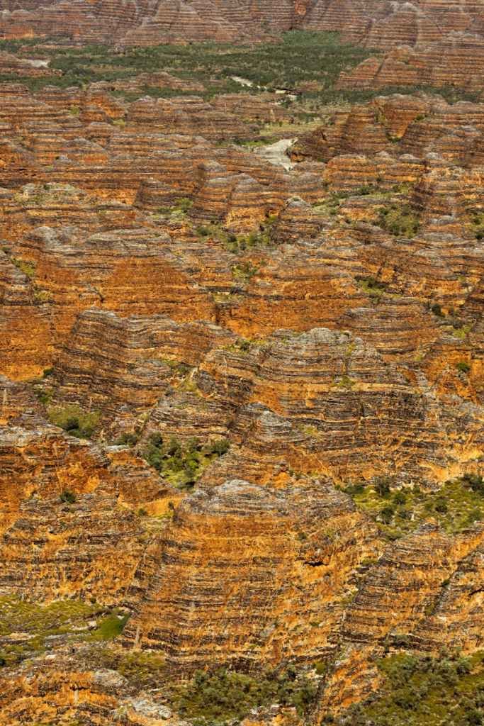 Explore the unique striped rock formations of the Bungle Bungles in Purnululu National Park, Australia.