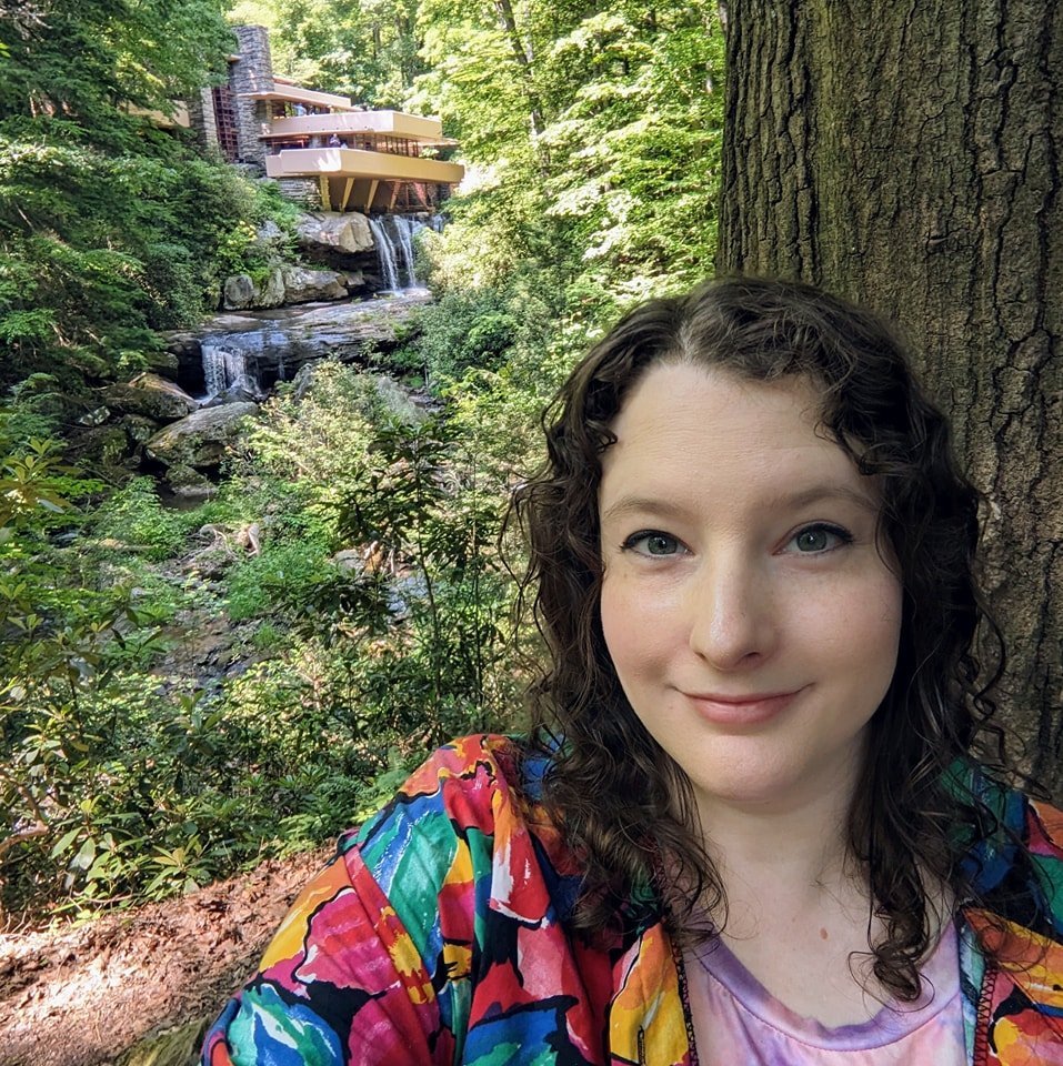 Headshot of a woman with brown hair in a colorful shirt