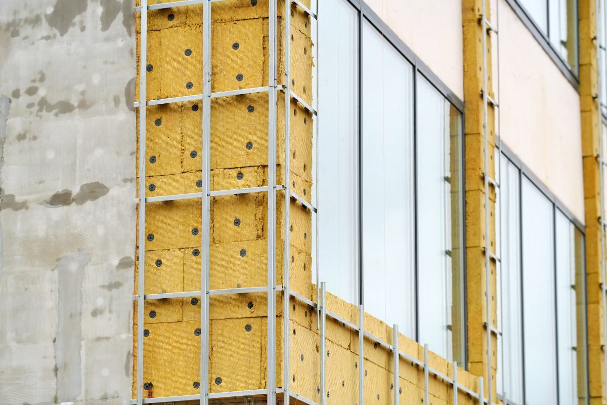 Building renovation work showing exposed facade of building, which is being prepared for cladding