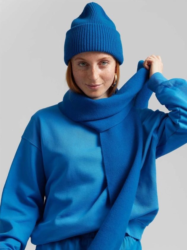 model wearing coordinated cobalt blue recycled wool scarf and beanie by colorful standard 