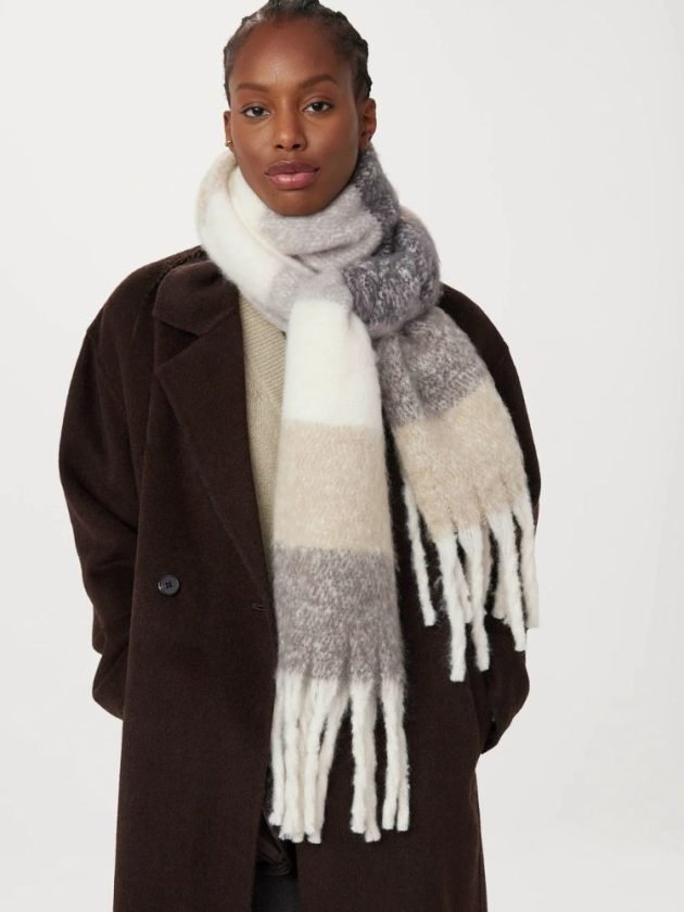 model wearing striped fuzzy knit scarf by Frank & Oak