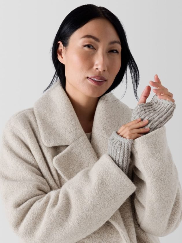 Model wearing sequinned merino wool sustainable winter gloves by Eileen Fisher