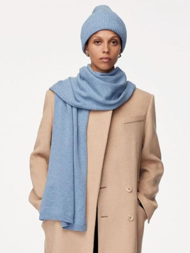 Model wearing coordinated blue recycled cashmere beanie and scarf by Another Tomorrow 