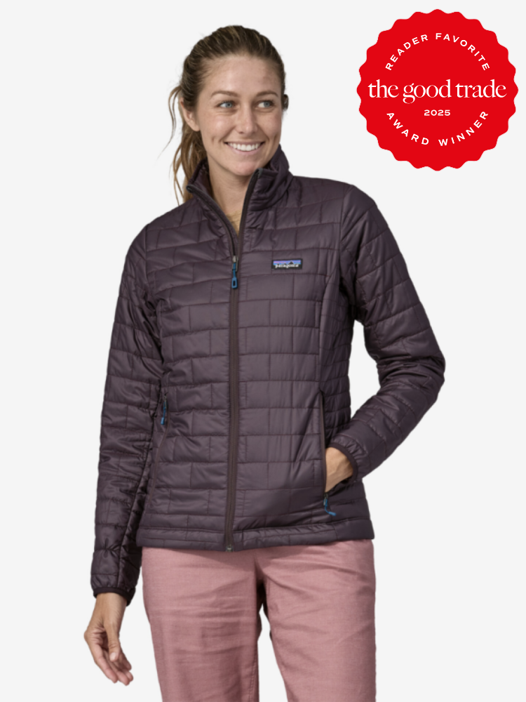 Woman in a dark quilted jacket and pink pants smiling, with a "The Good Trade Reader Favorite Award Winner 2025" badge in the top right corner.
