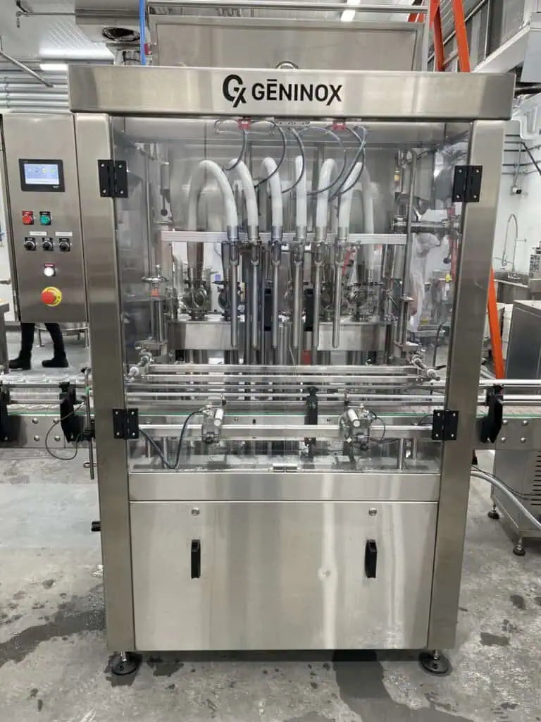 Automated hot sauce filling machine in action at a production facility