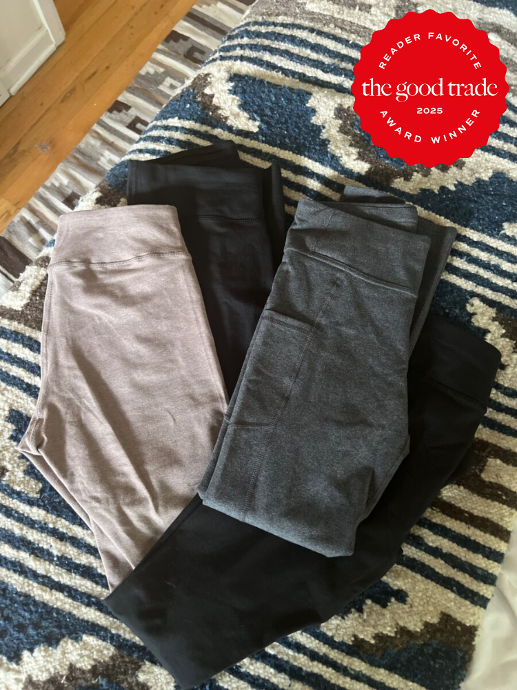 Folded leggings in beige, black, and gray on a patterned surface. A "Reader Favorite: The Good Trade 2025 Award Winner" badge is in the top right corner.