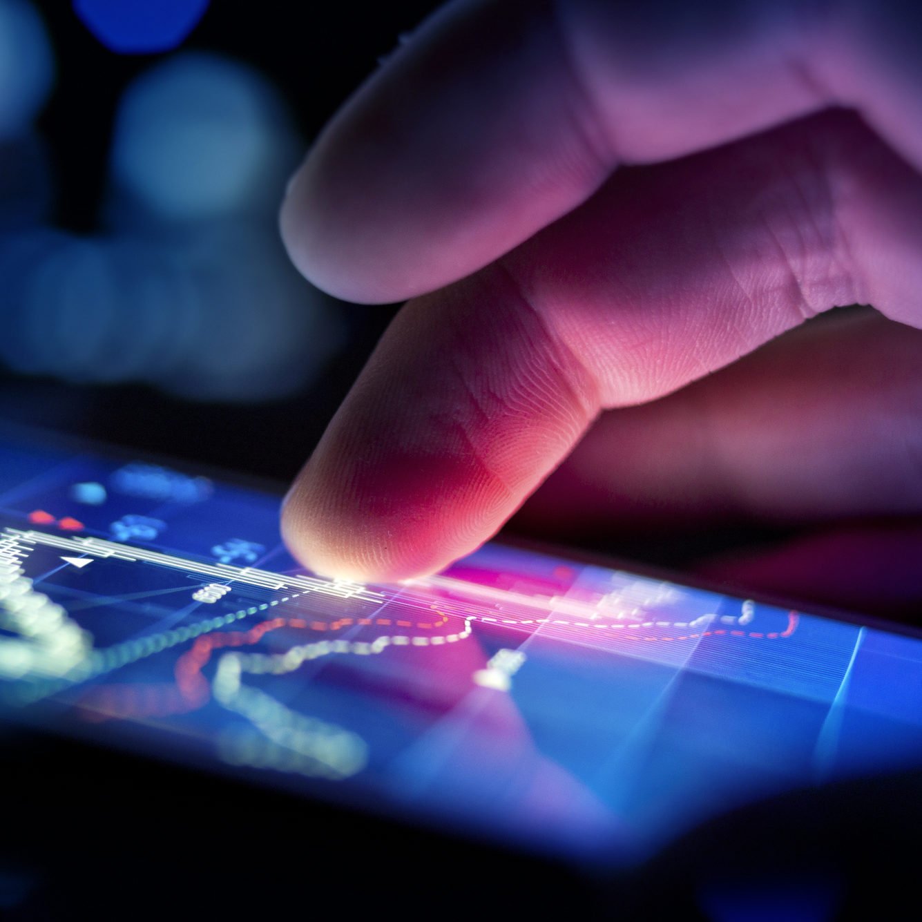 closeup of app-based control - hand and glowing screen