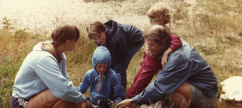 Bodsworth family studying plants in the dunes at a beach