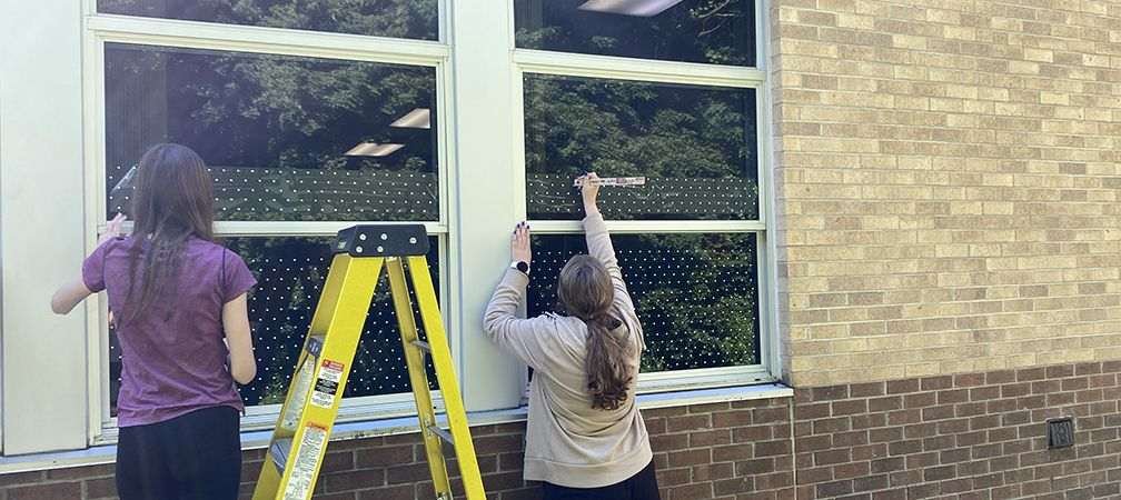 With support from the Upper Thames River Conservation Authority, students treat their classroom windows for bird safety in Ingersoll, Ontario © Brendon Samuel