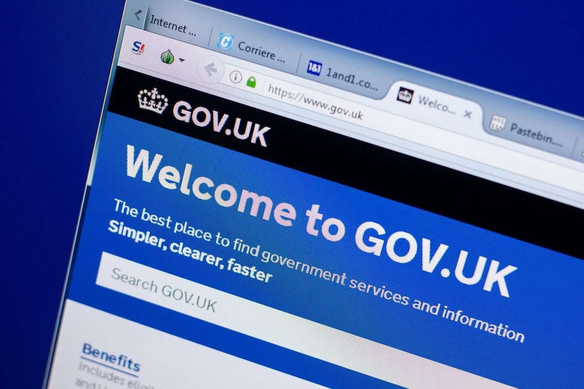 View of a laptop screen from above, and slightly to the side, displaying UK government website landing page