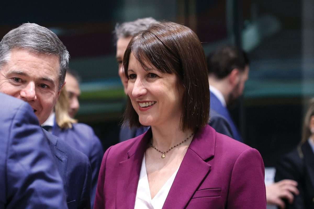 UK Chancellor Rachel Reeves standing amidst a group of people, smiling