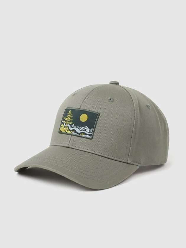 Green baseball cap with nature scene made with eco-friendly materials