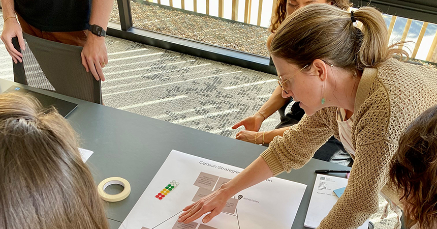 Juliette Grummon-Beale pointing at a design on a table
