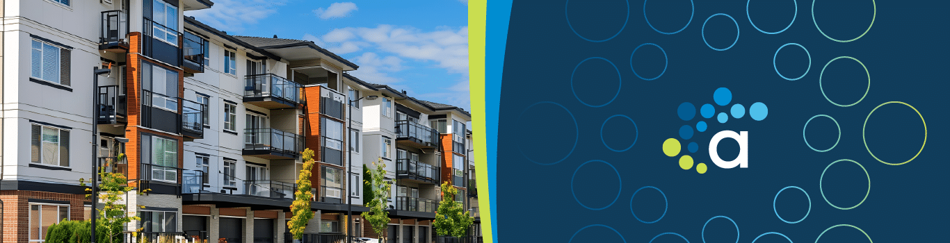 Modern multifamily building with balconies under a blue sky, representing energy-efficient housing solutions