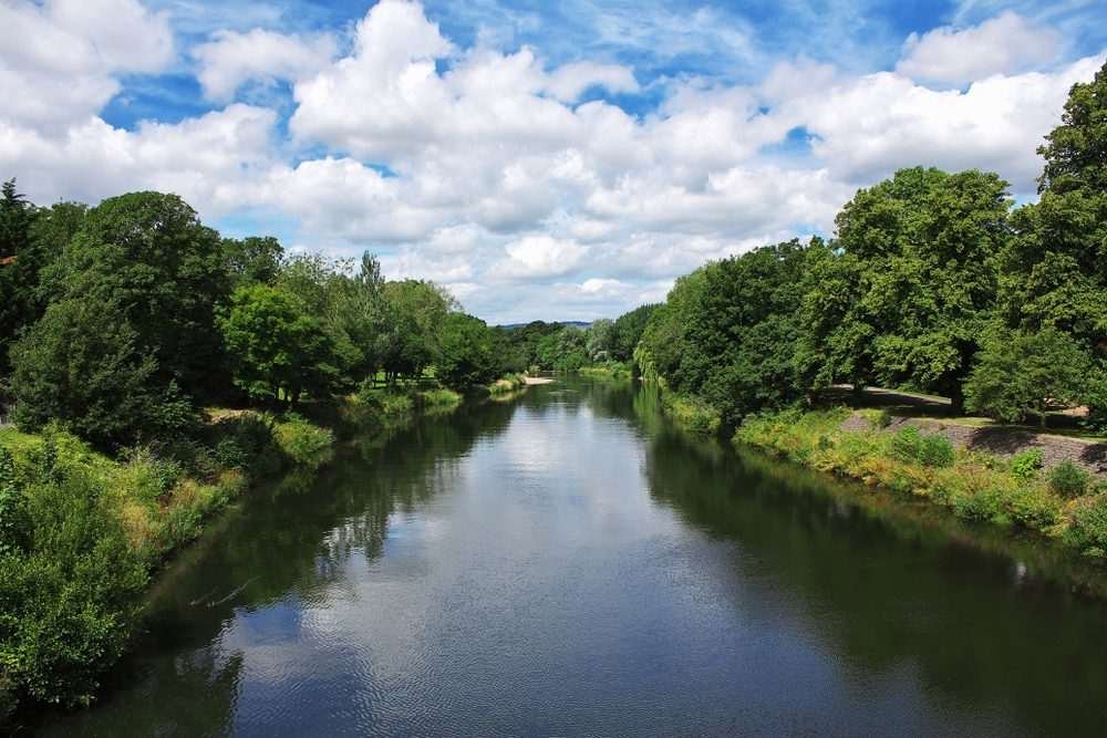 An aerial view of a UK river in a rural location