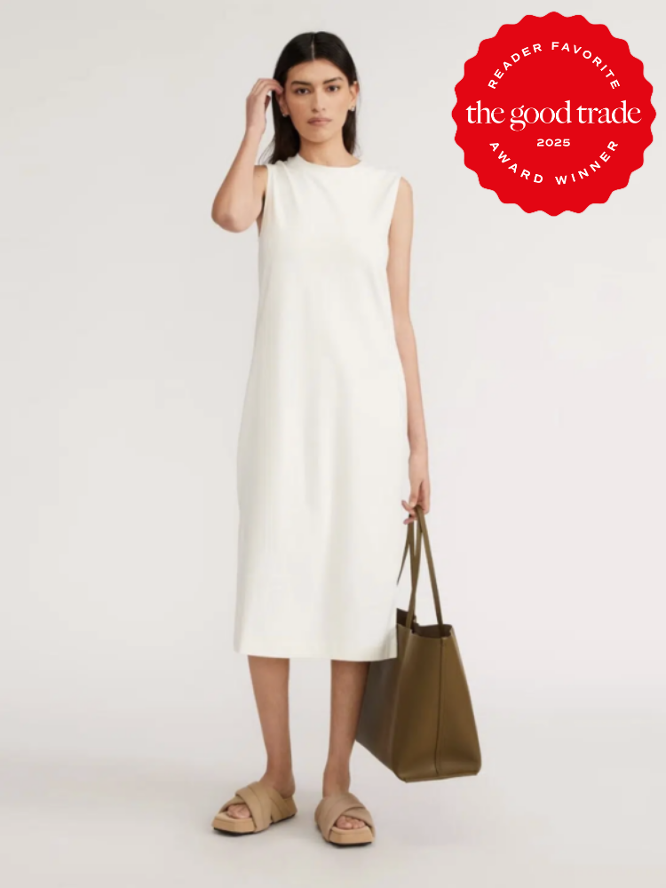 Woman in a sleeveless white dress, holding a brown tote bag. Red award badge in the top right corner reads "Reader Favorite The Good Trade 2025 Award Winner.