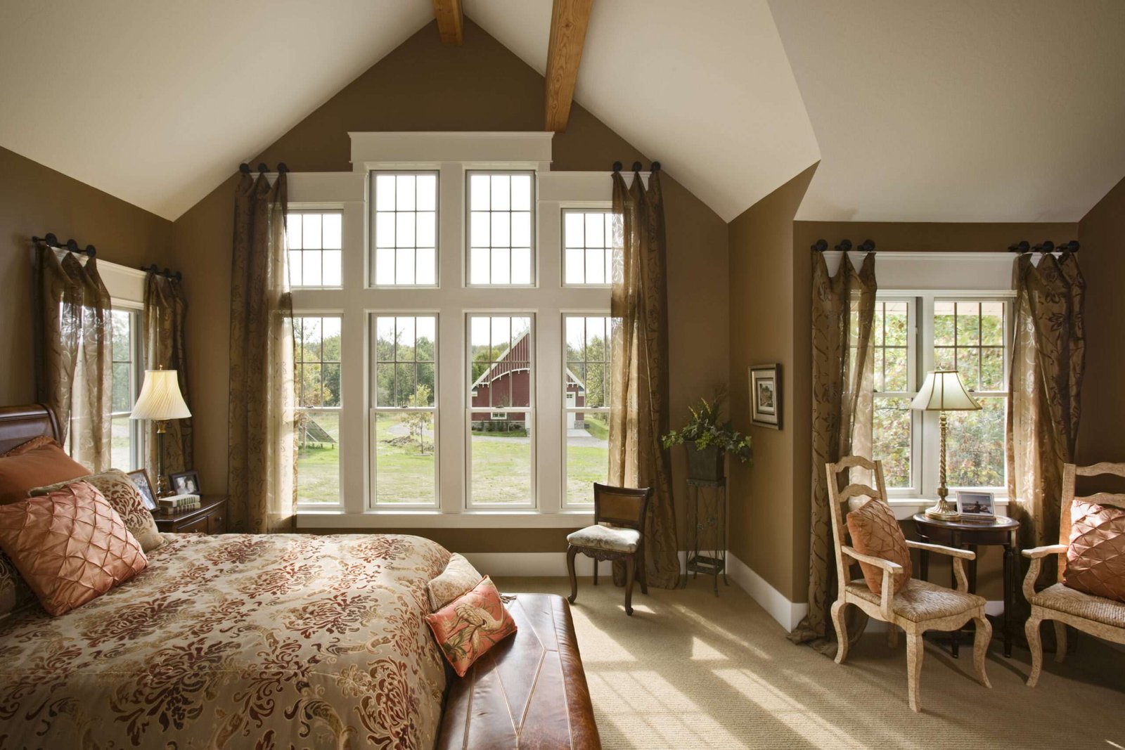 Interior of SIPs home, luxury-appointed bedroom with backyard views through large windows - photo