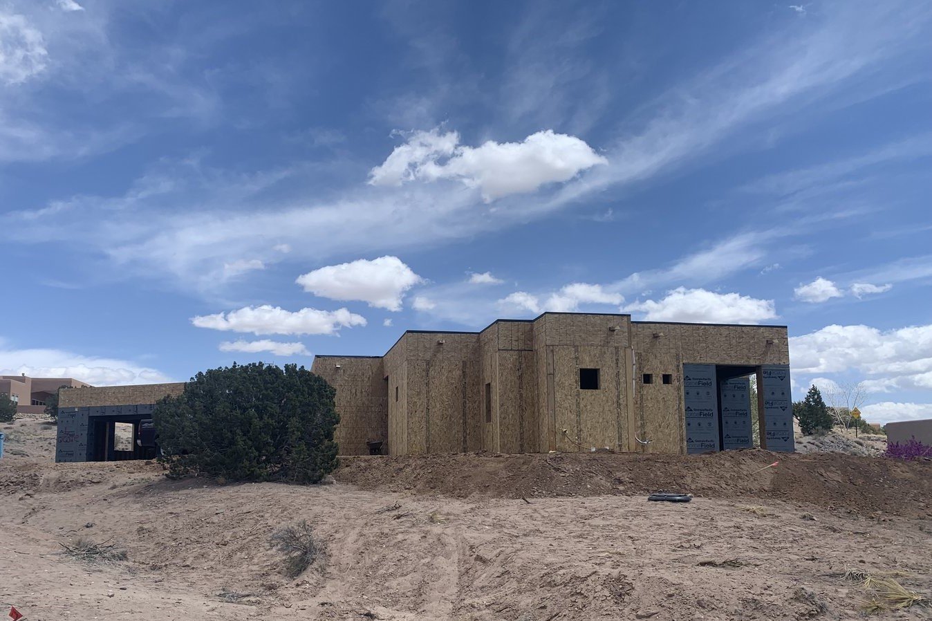 exterior view of SIP panel prefab home under construction in desert setting; by SIP panel manufacturer Premier Building Systems - photo