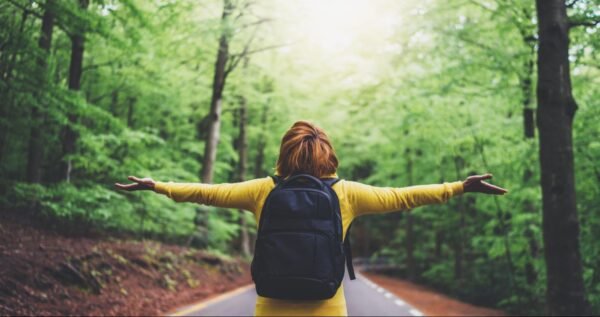 A person outside with their arms outstretched