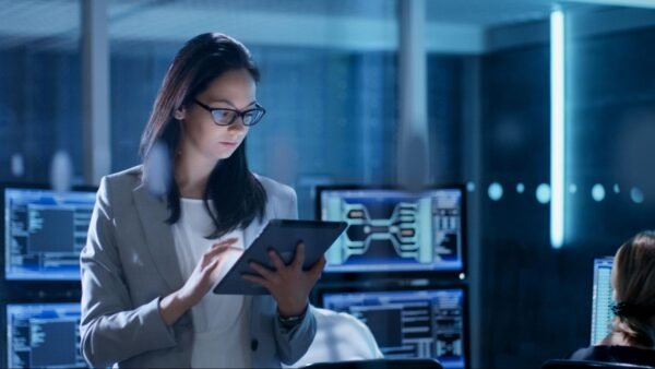 woman holding a tablet in a tech room