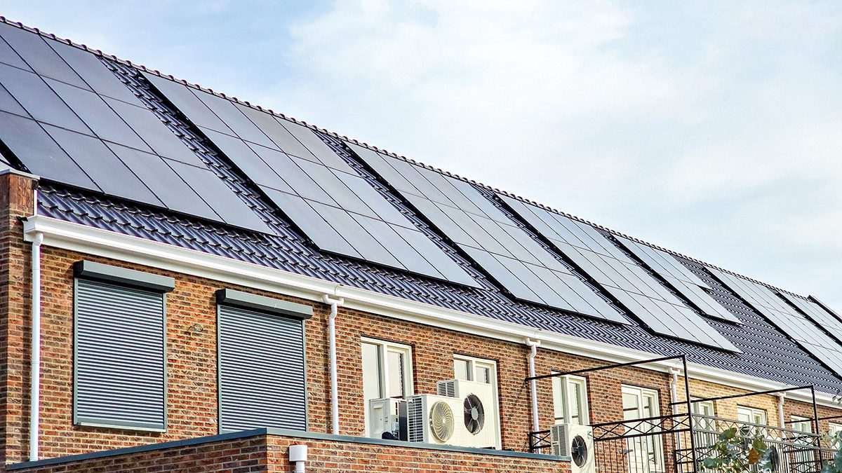 Rooftop solar panels and a heat pump visible on exterior of residential property