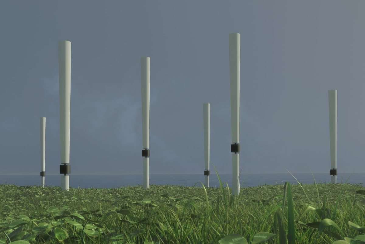 Tall, white, cylindrical structures arranged in a field-like landscape in an outdoor location