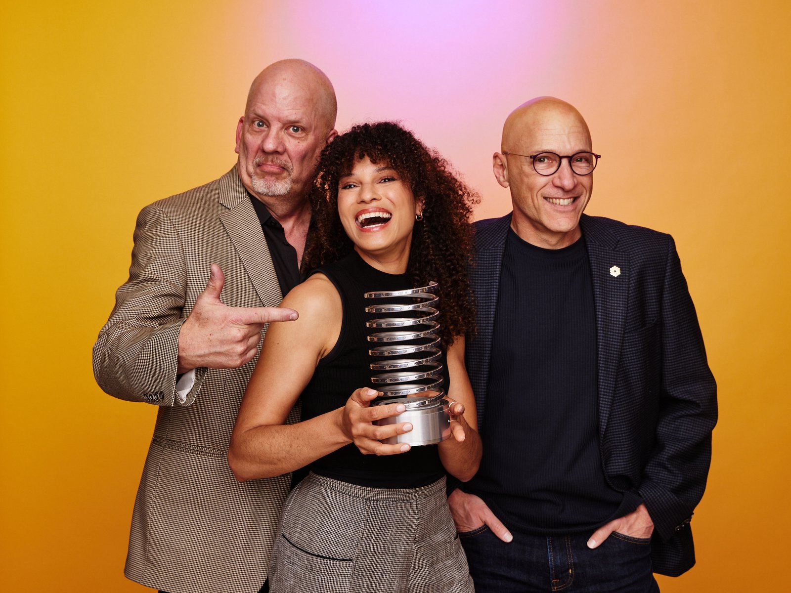 Sophia and two coworkers hold a shared award