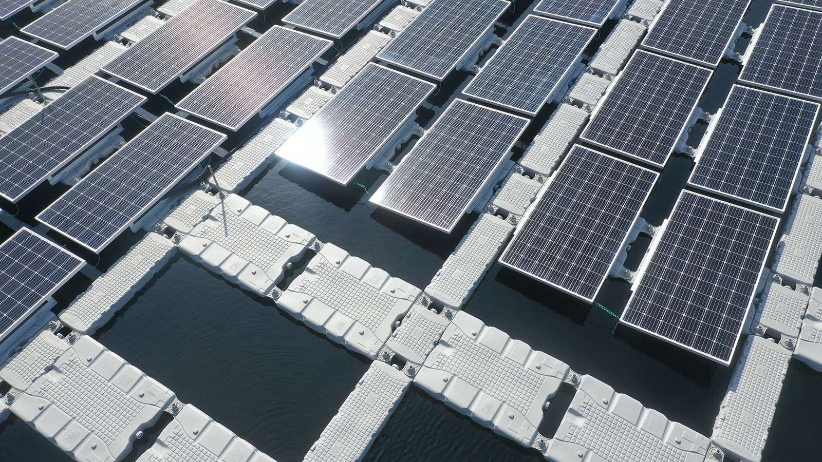 Aerial view of platforms on water with solar panels attached