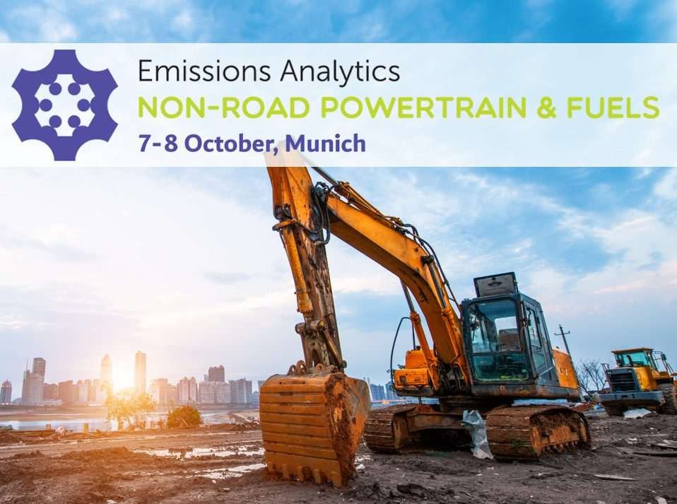 An event flyer showing a piece of earth-moving equipment on semi-derelict construction ground with a modern cityscape in the far distance near the horizon, with various high-rise buildings' colours slightly bleached out by sunlight behind them, and the words on the flyer say: Emissions Analytics, Non-road Powertrain and fuels, 7-8 October, Munich