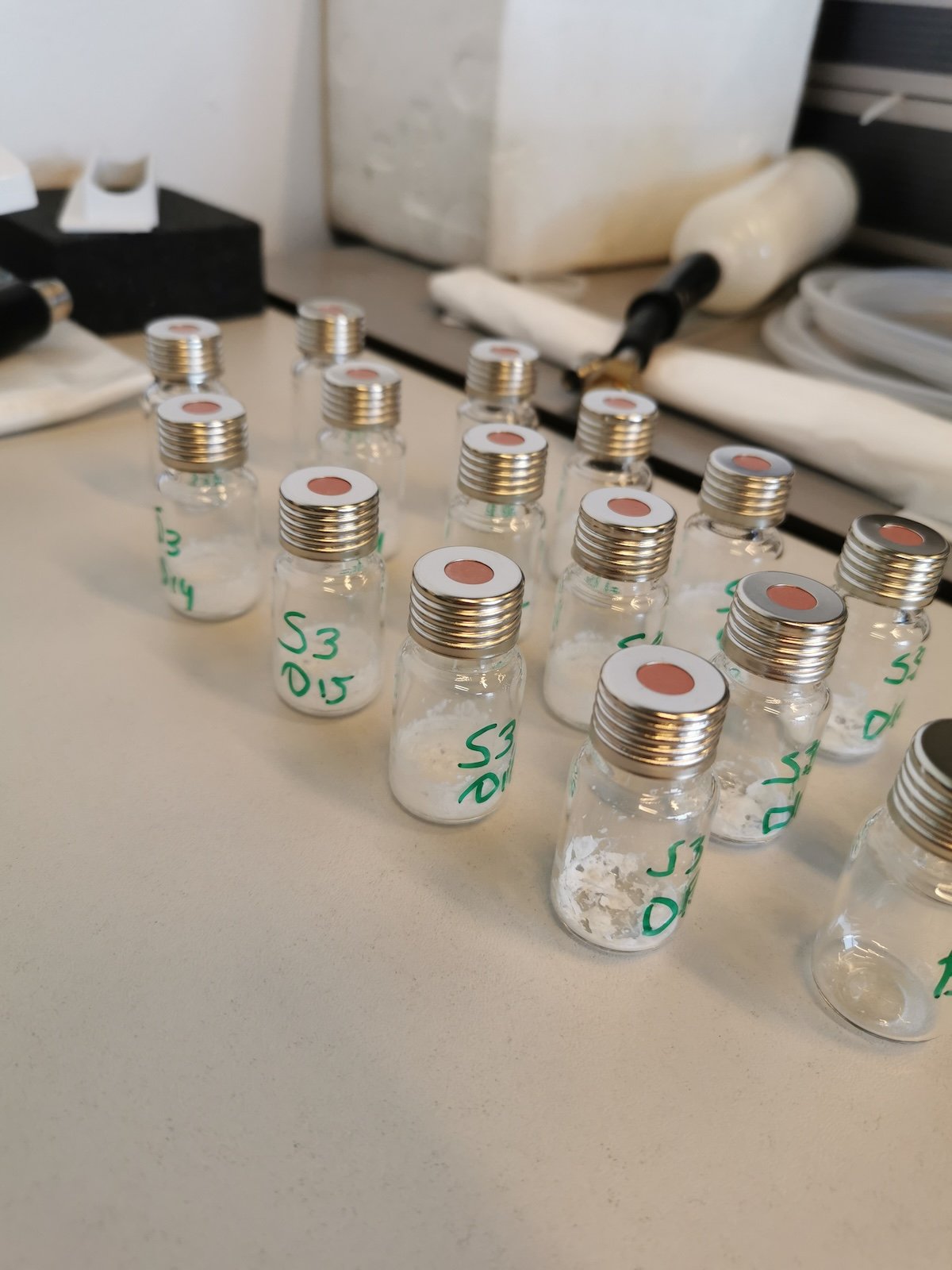 Labeled glass vials in a row, with salt residue visible at the bottom of each