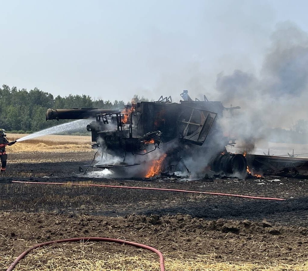 Firefighters from the Shelburne and District Fire Department attend to a fully engulfed combine in Amaranth Township wheat field. Photo source: Shelburne and District Fire Department