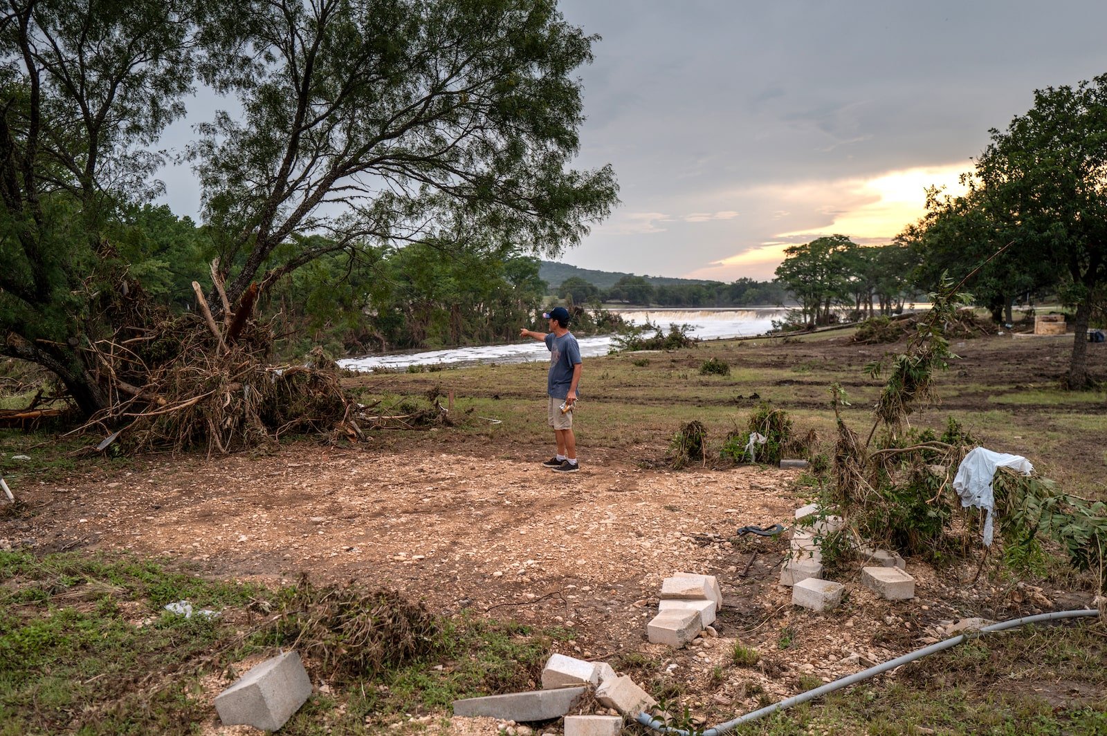 a man points while standing on an empty lot