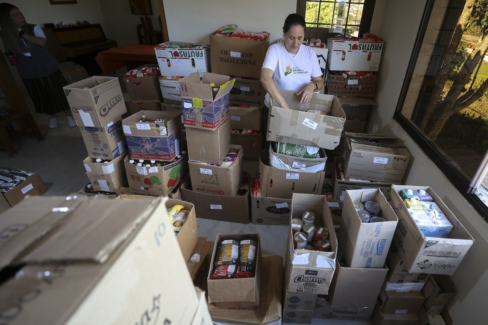 woman packs food in boxes for a food bank