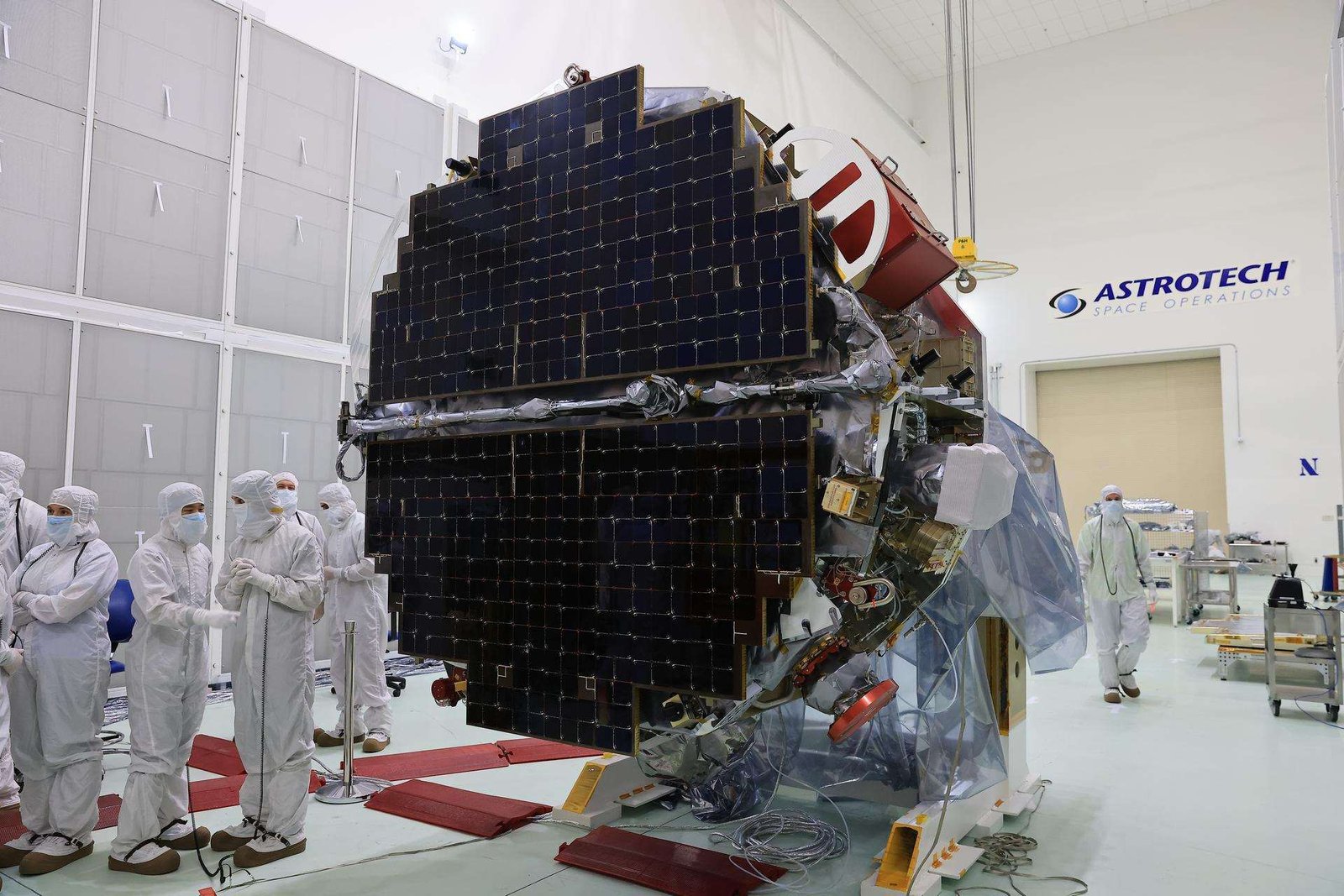 Technicians at the Astrotech Space Operations Facility near NASA’s Kennedy Space Center in Florida conduct illumination testing on Friday, July 18, 2025, by flashing a bright light that simulates the Sun into the two-panel solar array that will help power the agency’s IMAP (Interstellar Mapping and Acceleration Probe) observatory on its upcoming journey to a destination about one million miles away from Earth Lagrange Point 1.