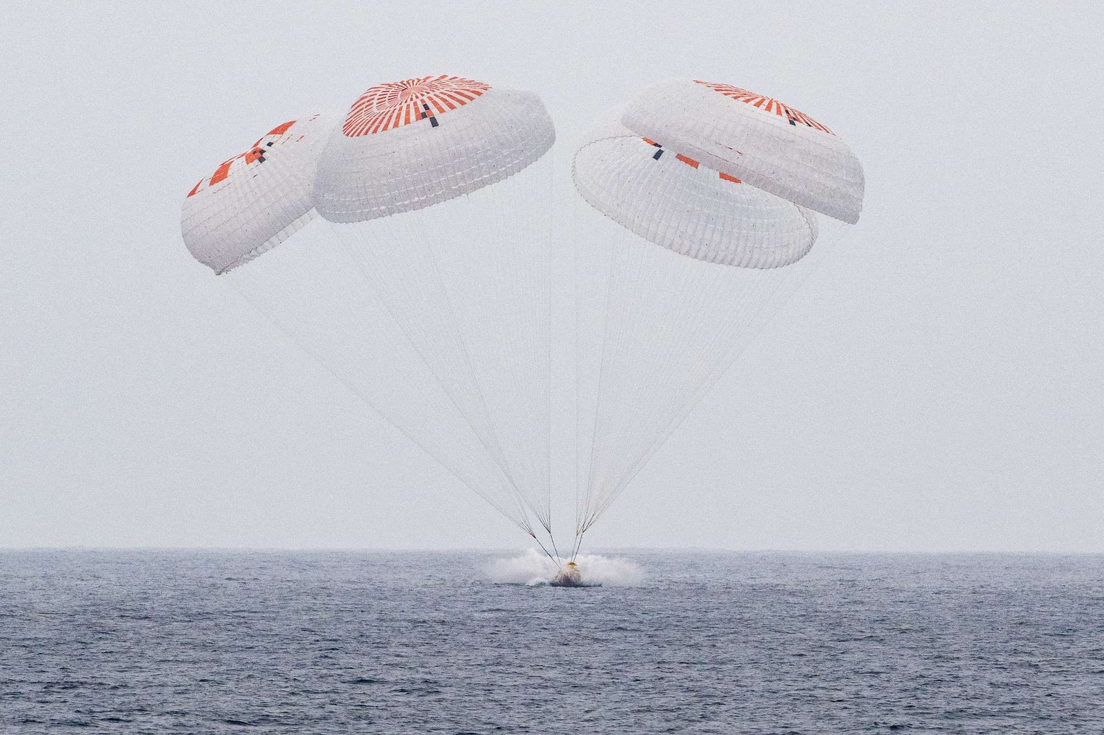 The SpaceX Crew Dragon Endurance spacecraft is seen as it lands with NASA astronauts Anne McClain and Nichole Ayers, JAXA (Japan Aerospace Exploration Agency) astronaut Takuya Onishi, and Roscosmos cosmonaut Kirill Peskov aboard in the Pacific Ocean off the coast of San Diego, Calif., Saturday, Aug. 9, 2025. McClain, Ayers, Onishi, and Peskov are returning after seven-months in space as part of Expedition 73 aboard the International Space Station.