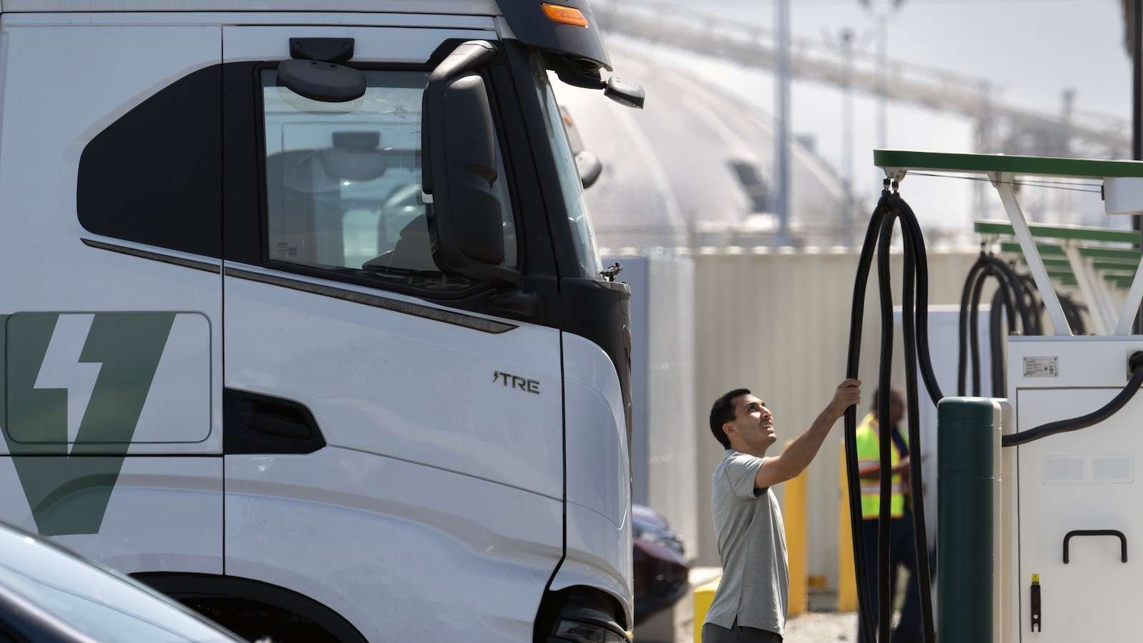 A truck driver prepares to plug in his big-rig at the Port of Long Beach.