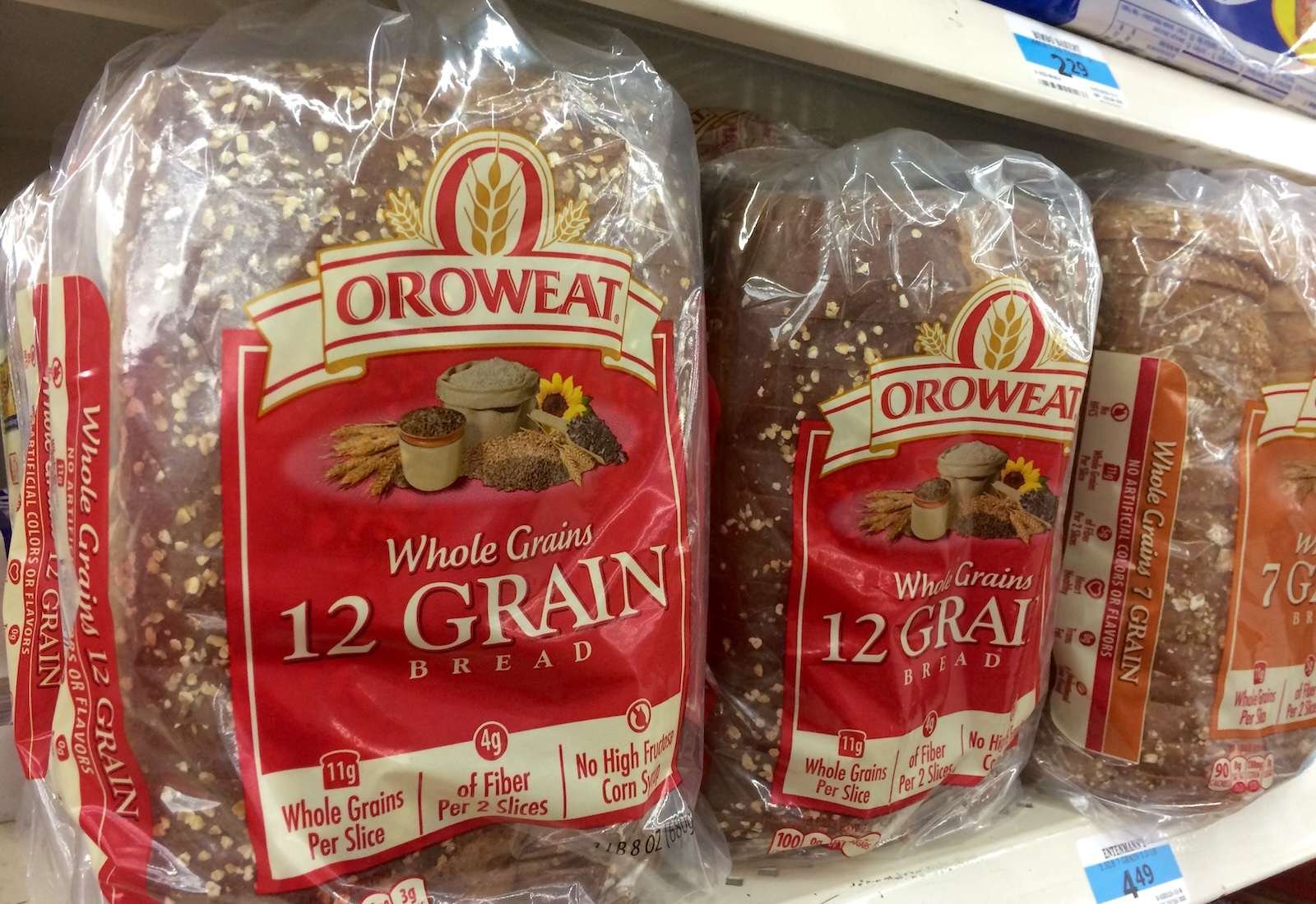 Oroweat-brand bread in plastic packaging lining a grocery store shelf