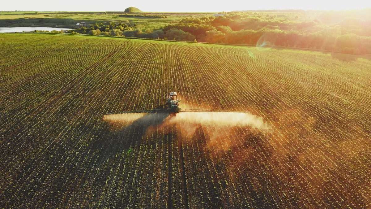 Vehicle spraying a field of crops