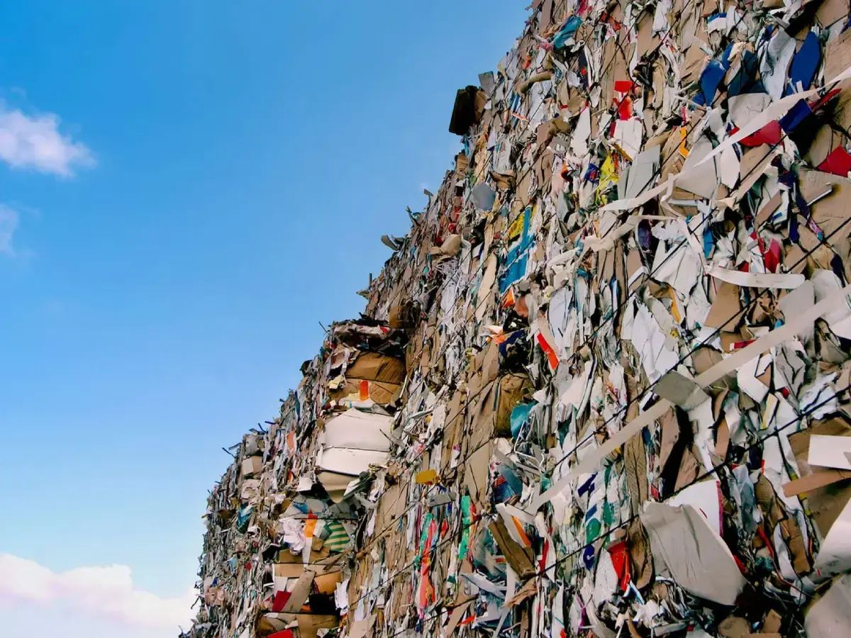 A stack of baled waste seen against a blue sky.