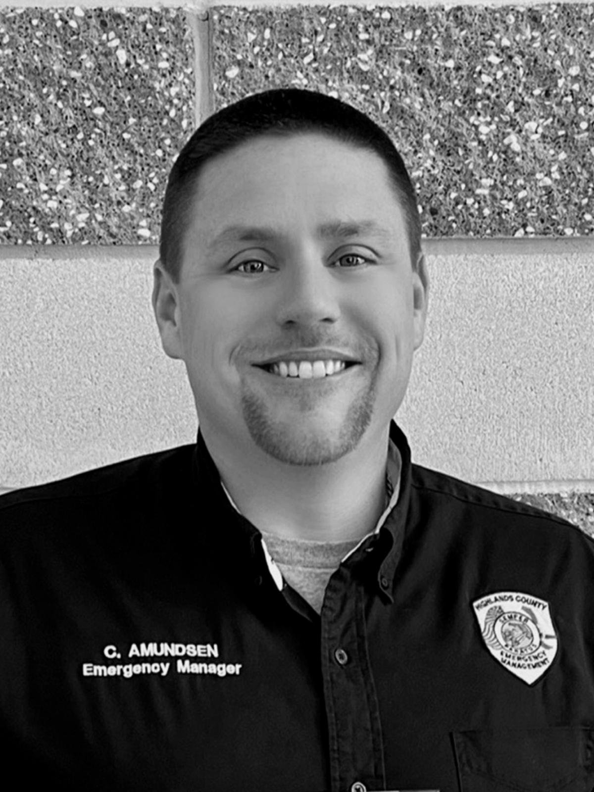 A black and white phot of a man in a a uniform with a badge
