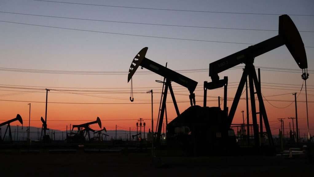 Oil pump jacks with the sun setting in the background