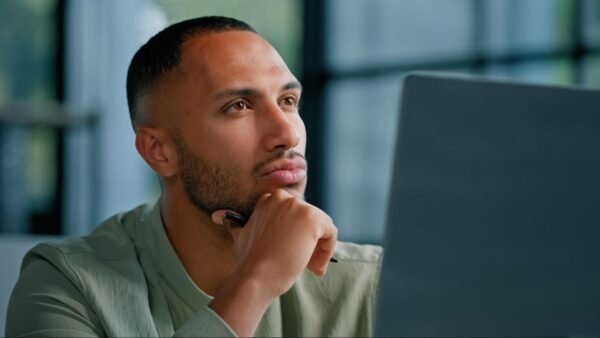 a man looking at a laptop screen