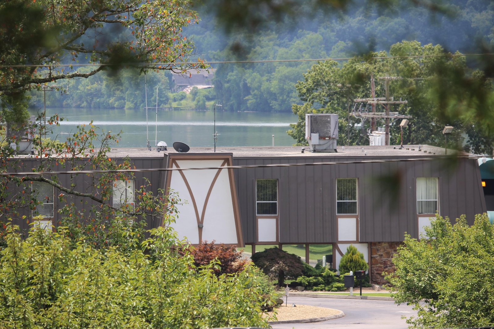 A small building sits on the banks of a river