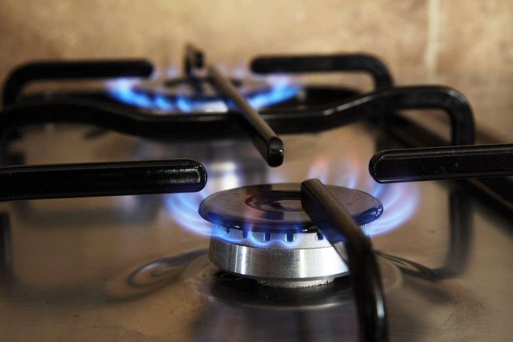 Close up image go two gas stove hobs.