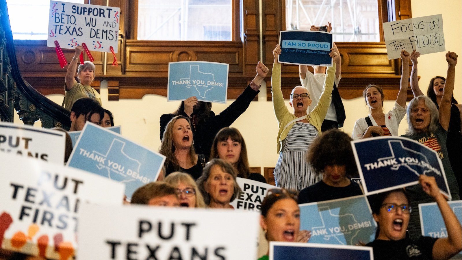Demonstrators chant as lawmakers are welcomed back ahead of a House meeting in the state Capitol in Austin, Texas.