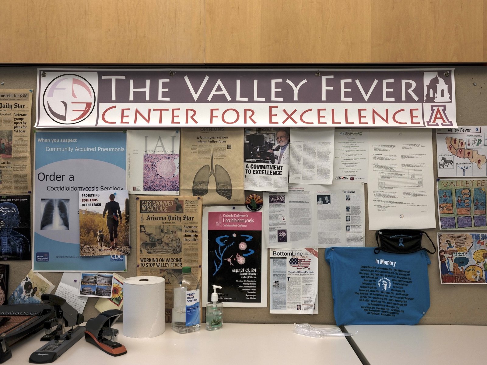 posters and drawings on a bulletin board for the valley fever center for excellence