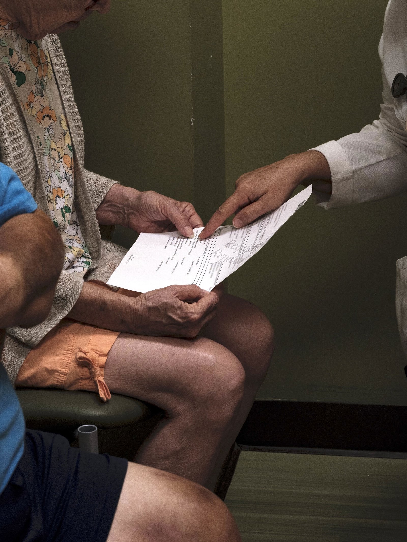 a doctor hands a patient a sheet of information on valley fever